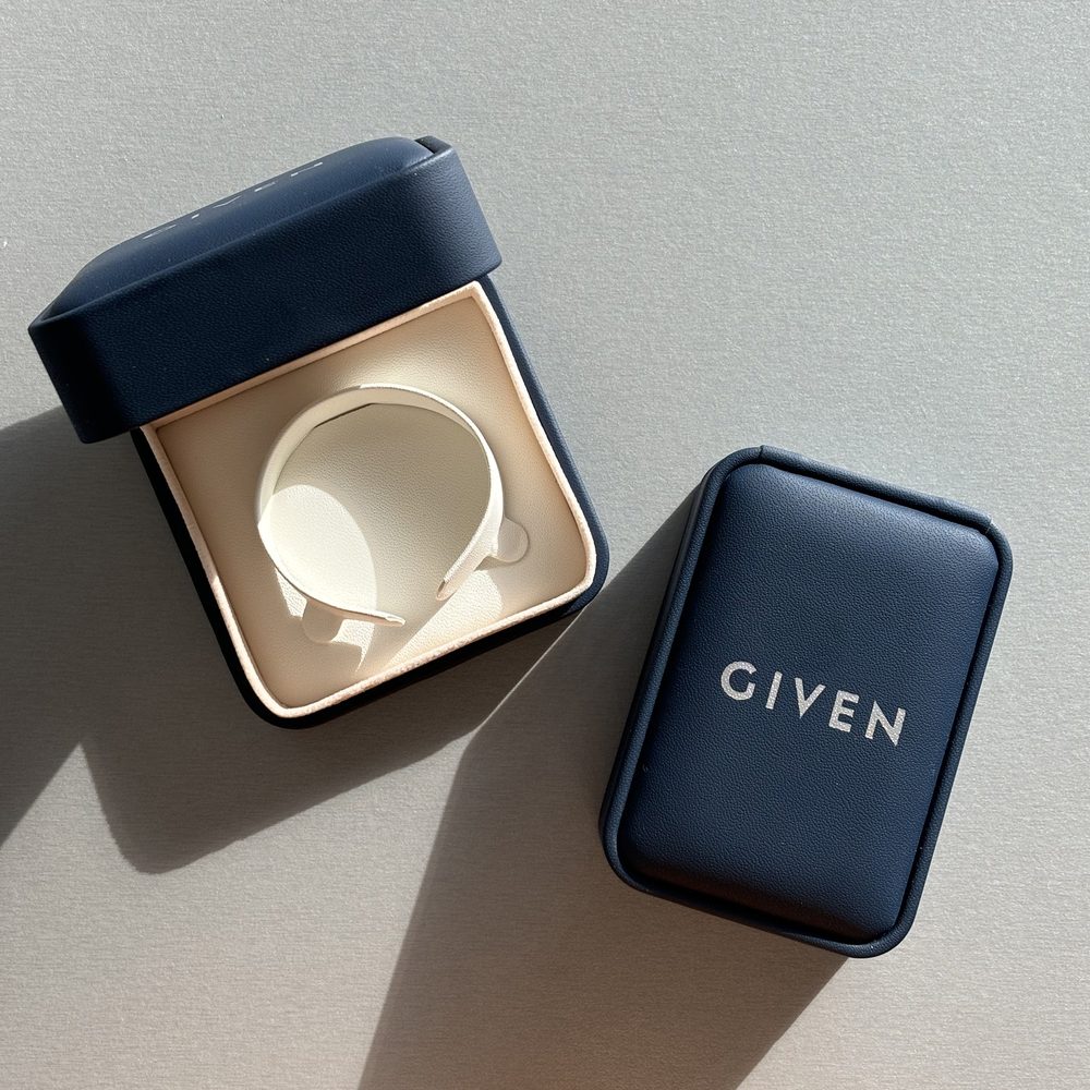 A navy GIVEN jewellery box, open